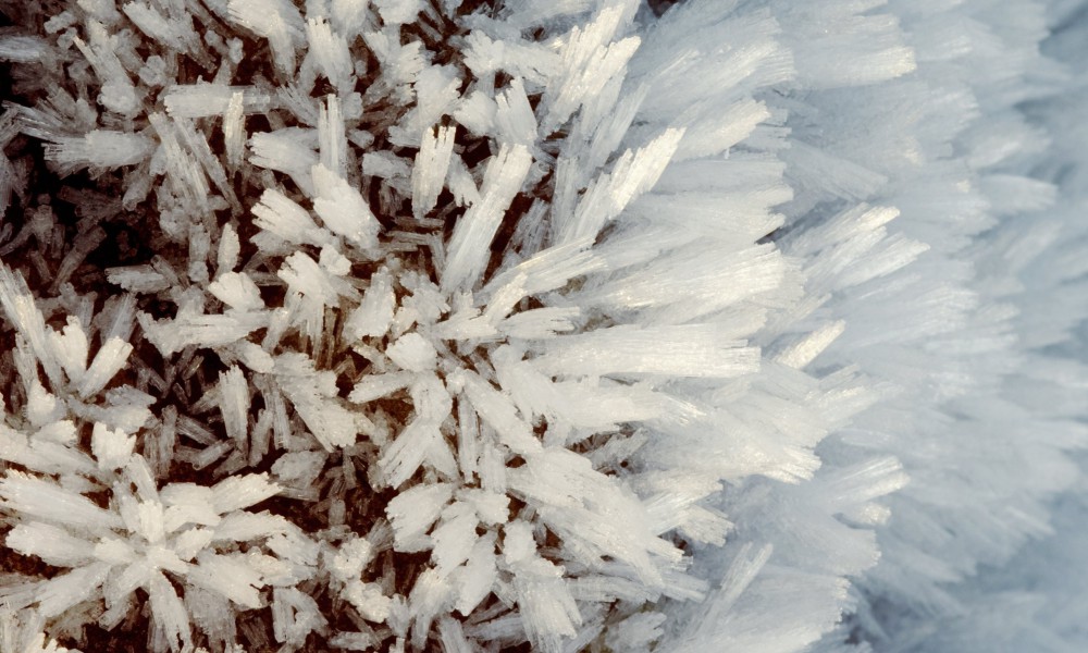 Kristaller av rimfrost på en klippa